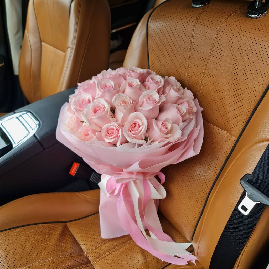 Blushing Pink Roses Bouquet In A Car