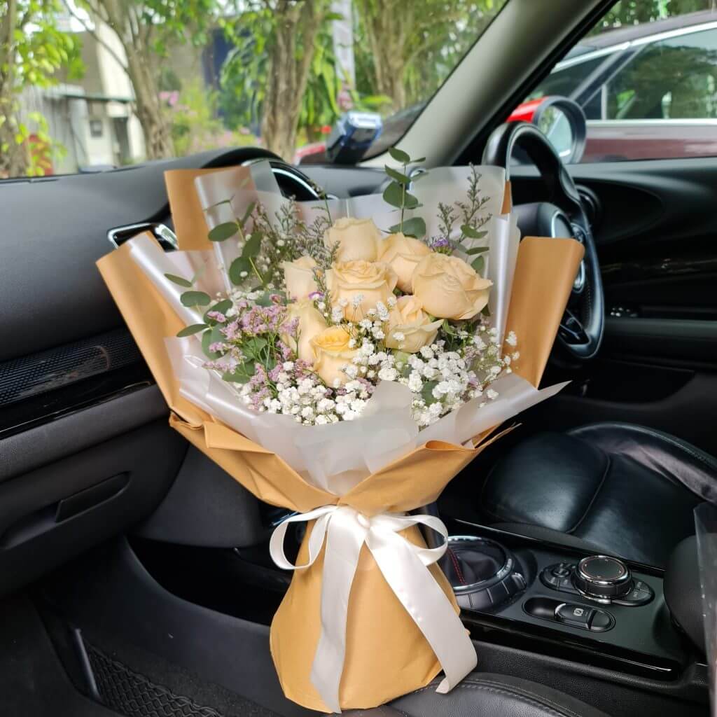 Shimmering Gold Roses Bouquet In A Car
