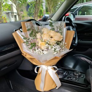 Shimmering Gold Roses Bouquet In A Car